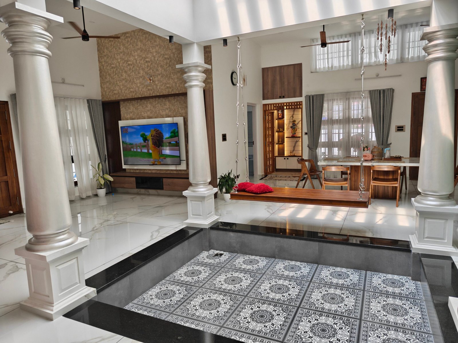 Traditional living room with pillars and a patterned rug