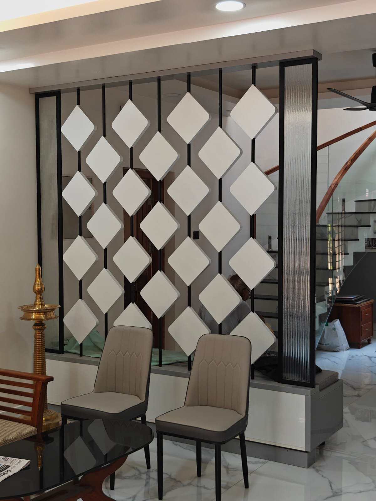 Living room with backlit shelving and stone feature wall